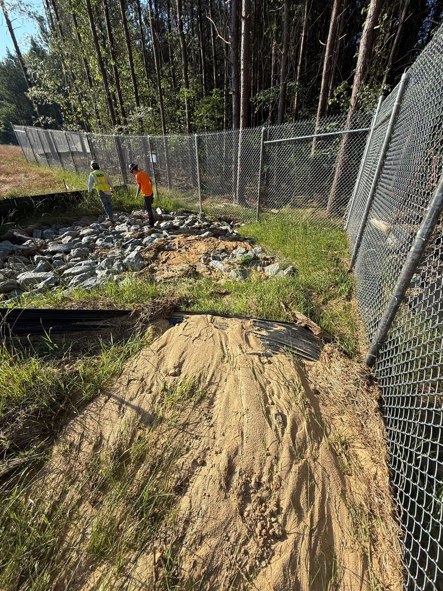 Reinforced perimeter controls protecting a stabilized slope