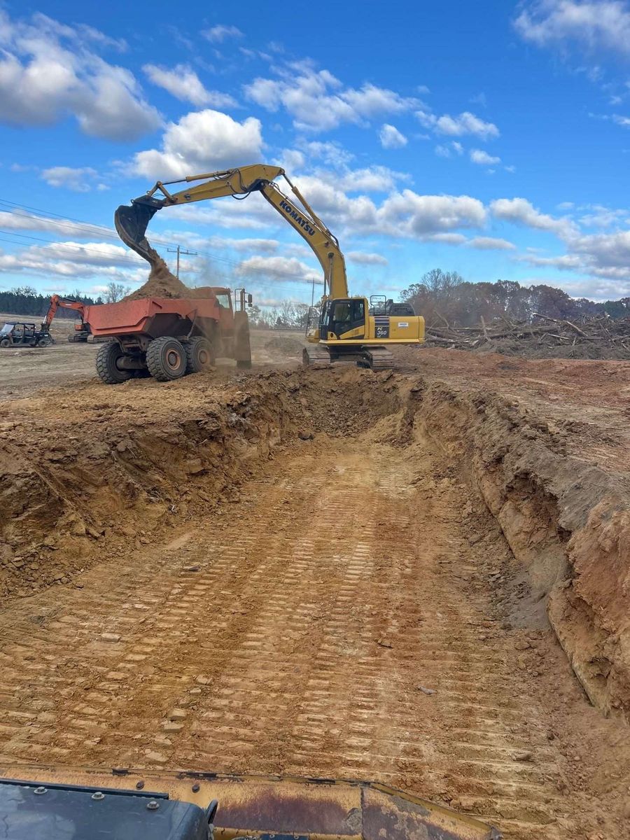 Excavator loading a haul truck during bulk earthmoving