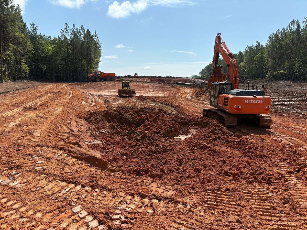 Excavators performing mass earthwork for utility-scale solar construction