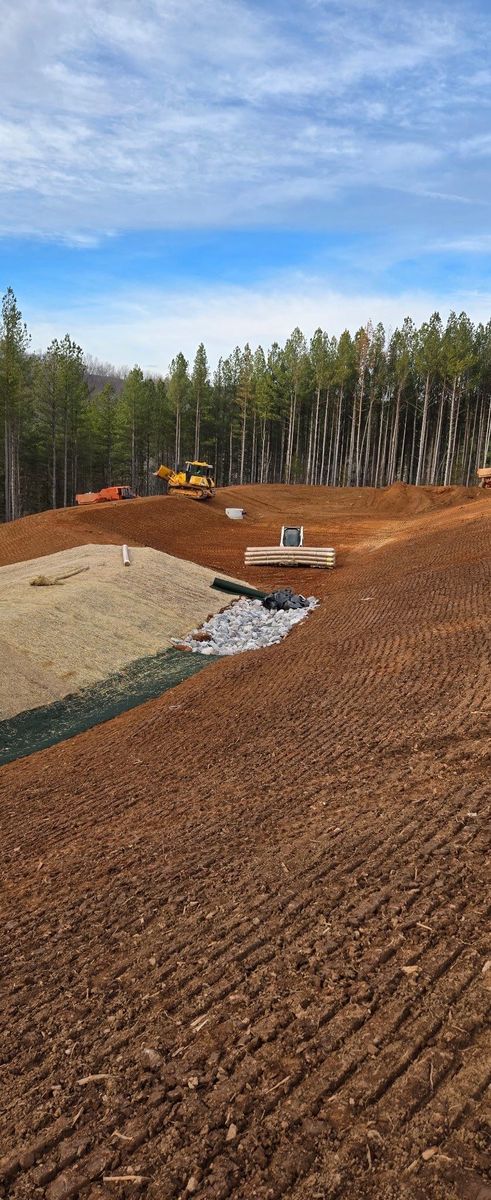 Stormwater basin inlet surrounded by stabilized soil and erosion-control matting