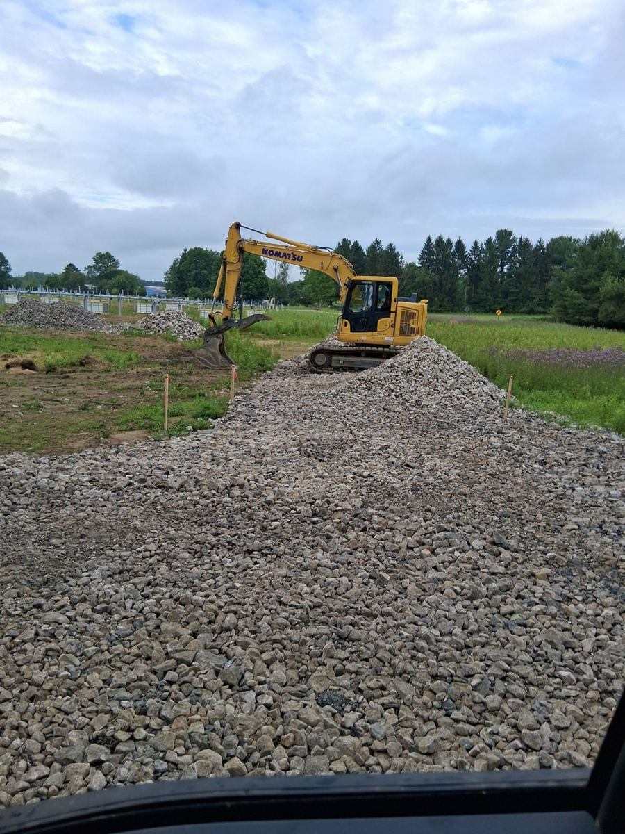 Excavator handling aggregate stockpiles at one of our sites