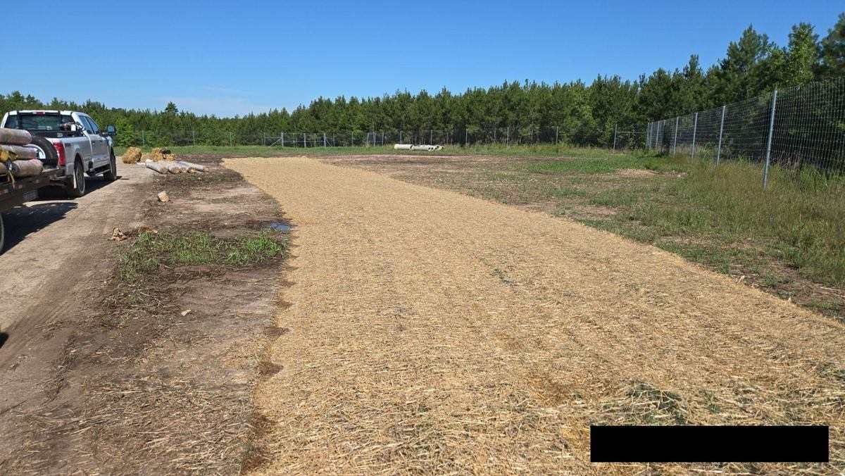 Seed and straw stabilization along a fenced solar site