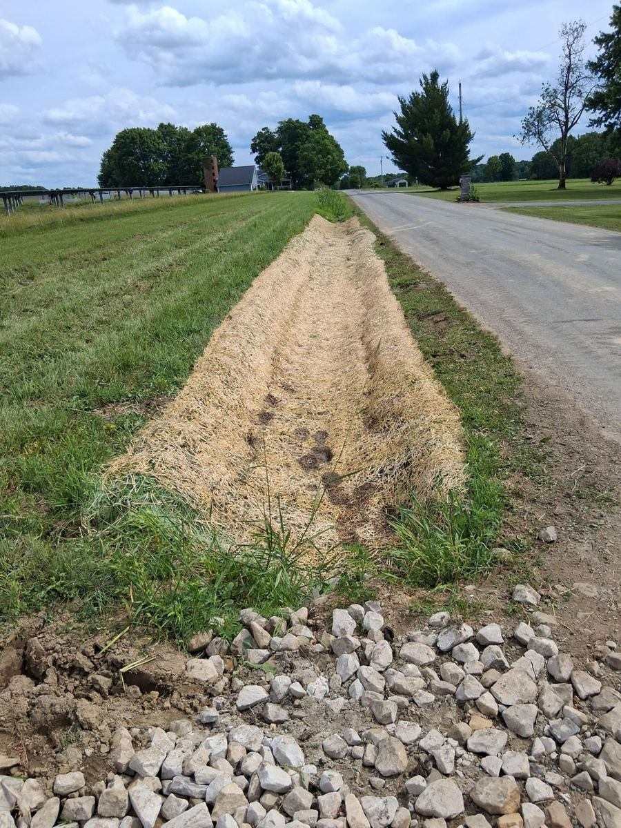 Straw-stabilized roadside ditch along a solar field