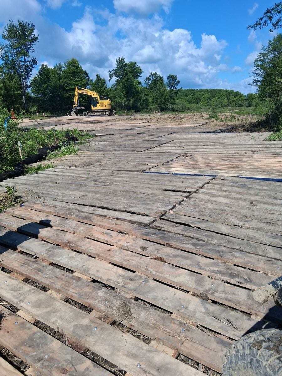Timber mat access road protecting soft ground